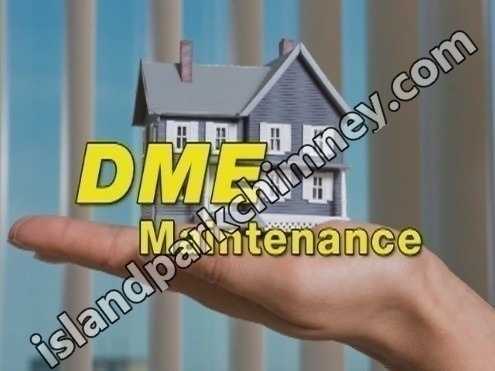 Professional chimney cleaning technician working on roof in Island Park, NY